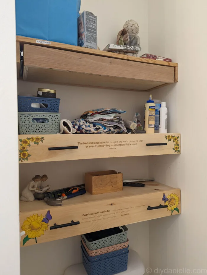 Two wooden drawer fronts fully installed next to a drawer box without its front panel, showing the progress of a DIY drawer project