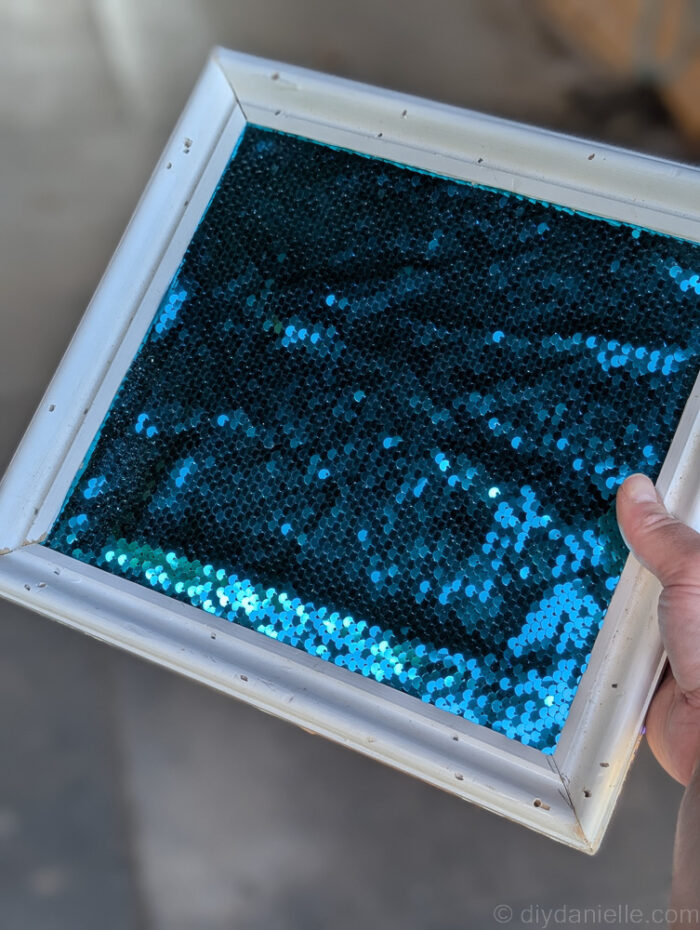 Close-up of fidget board edge, showing potential for improvement using trim with a built-in slot for a cleaner frame.
