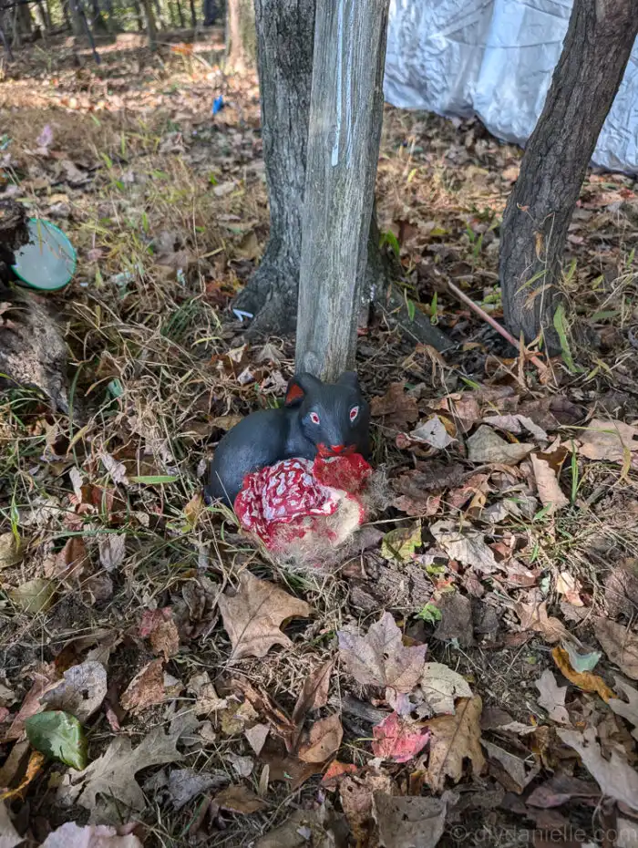 Close-up of red-eyed zombie bunny with cracked paint and horror-themed finish.