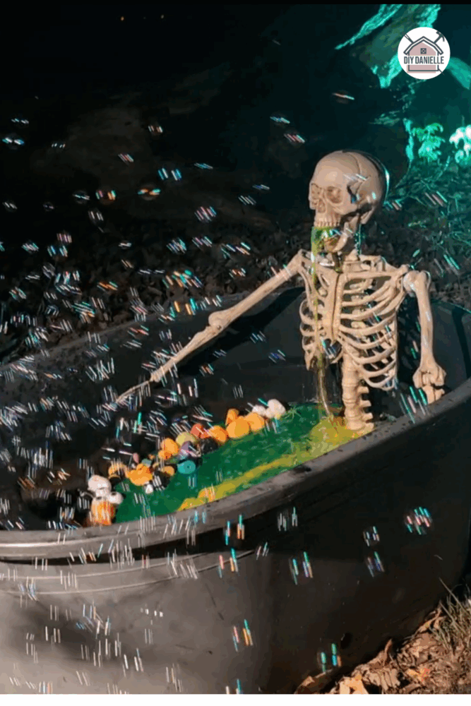 Halloween skeleton decoration in a bathtub with green water, rubber ducks, and a pump making it look like the skeleton is vomiting.