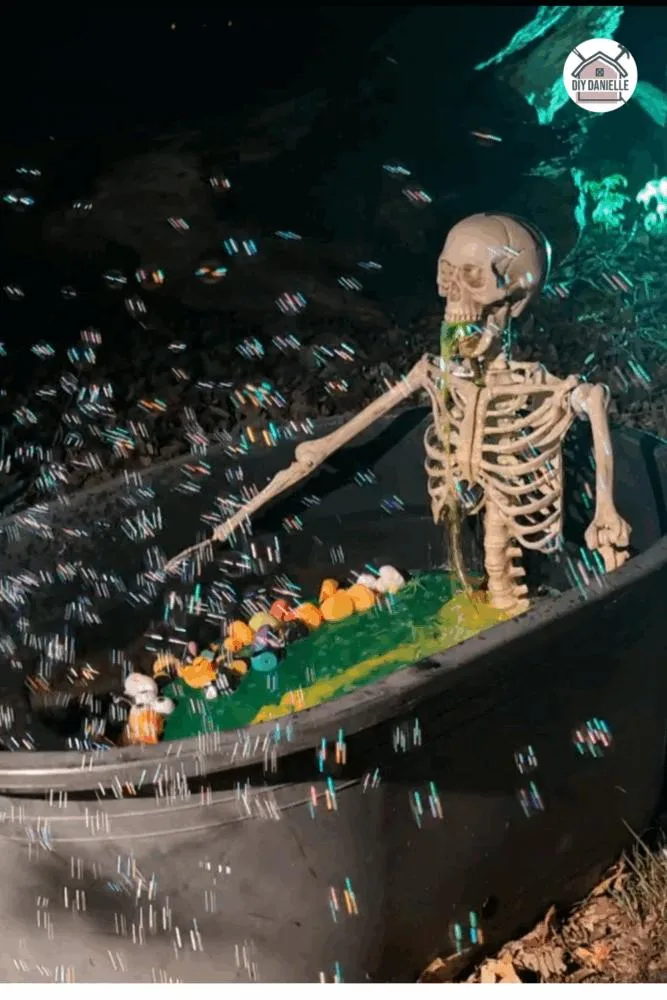 Halloween skeleton decoration in a bathtub with green water, rubber ducks, and a pump making it look like the skeleton is vomiting.