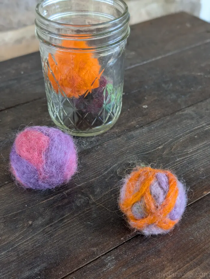 Container filled with needle felted catnip balls for cats to play with