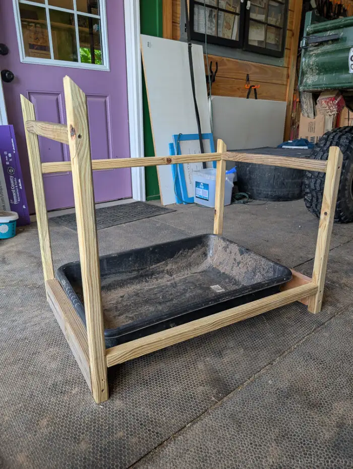 Wooden frame for outdoor litter box cover with long side pieces and bottom front support attached.