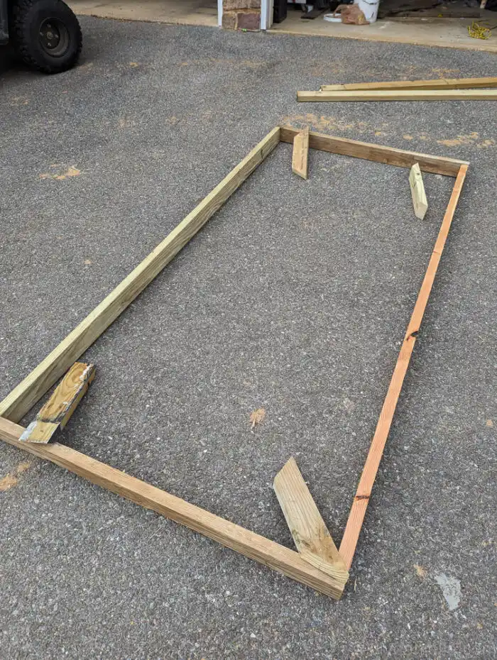 Basic wooden frame made from 2x4s for a DIY privacy screen project.