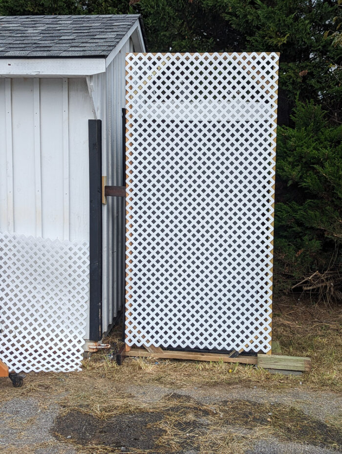 DIY privacy screen frame mounted to the side of a shed for extra support and stability.
