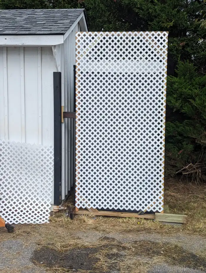 DIY privacy screen frame mounted to the side of a shed for extra support and stability.