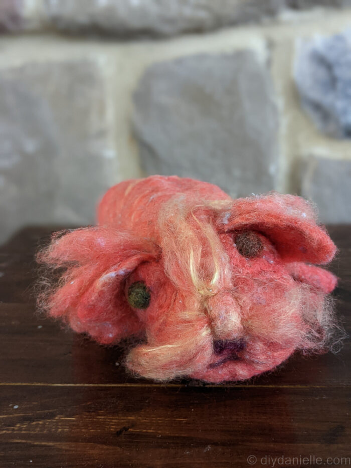 Small handmade needle felted dog figure crafted by a child