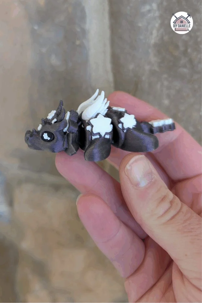 Small 3D printed flexible dragon toy designed for handheld play and fidgeting