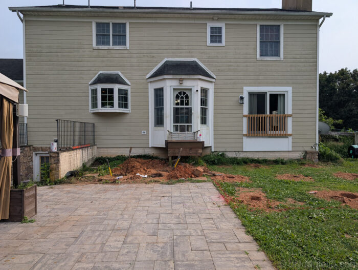Multiple post holes marked and dug, ready for deck posts.