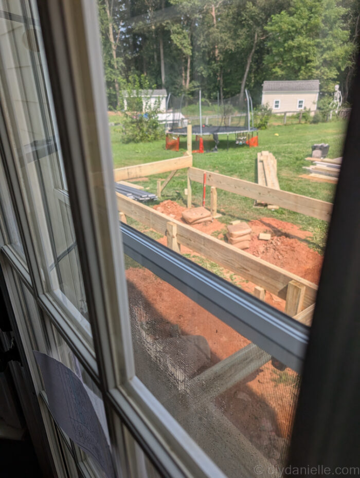 View of the new deck being built as seen through a window.