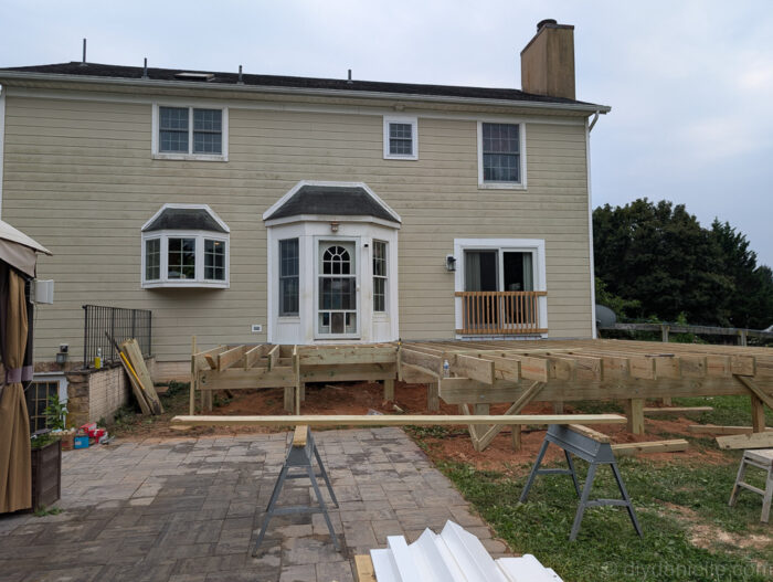 Backyard view showing the newly laid deck boards.