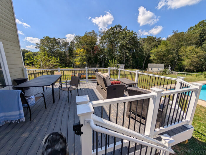 View of the deck from the stairs with furniture setup.