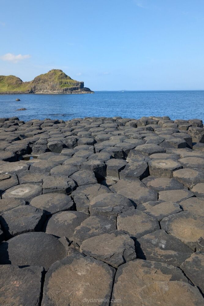 View of the hexagonal basalt columns at the Giant’s Causeway in Northern Ireland along the rocky coastline.