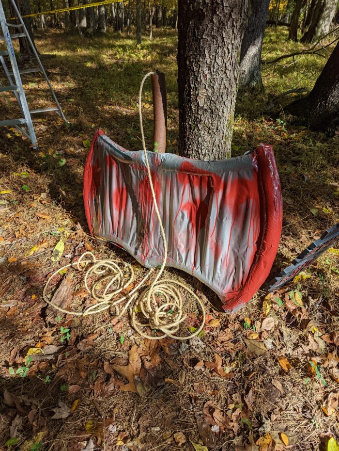 Collection of DIY Halloween props including cages, skeletons, and haunted house decorations.