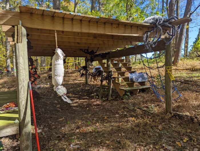 DIY Halloween tunnel setup with tarps along the sides to create an enclosed, spooky walkthrough for trick-or-treaters.
