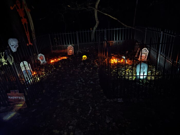 Overhead view of a small interactive graveyard fence for kids during the first year of a Halloween display.