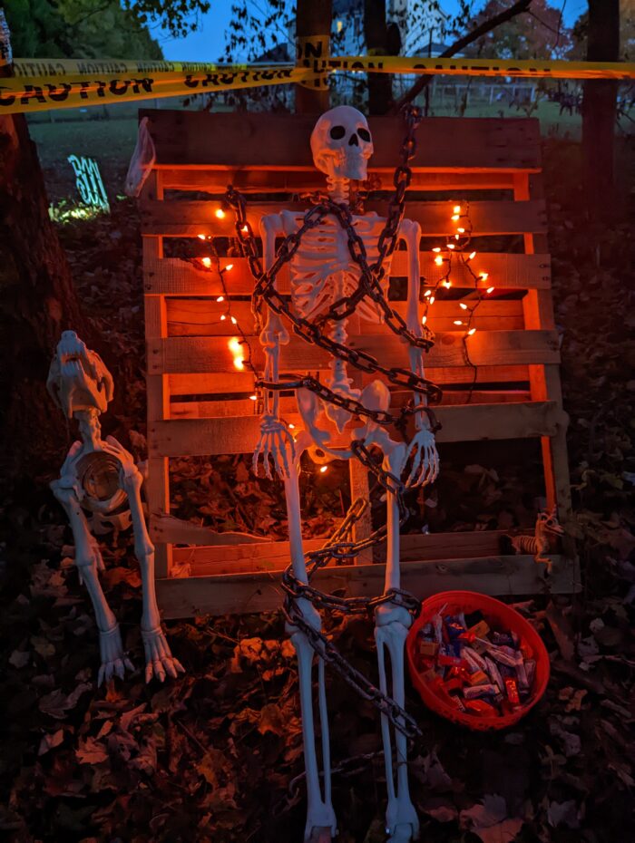 Various spooky DIY props set up for a Halloween prison and haunted theme.