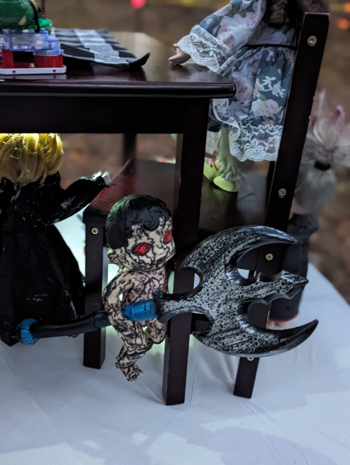 Thrift-store dolls transformed into spooky Halloween decorations for a witch-themed outdoor trail.