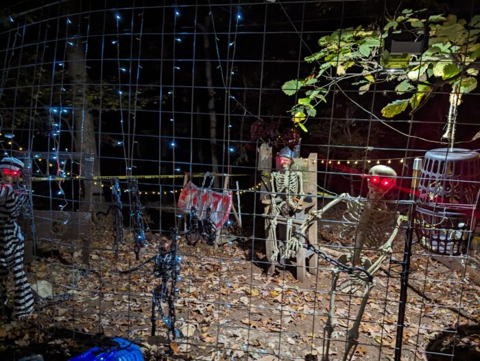 Hog panels propped up to form a DIY jail fence for Halloween decorations.