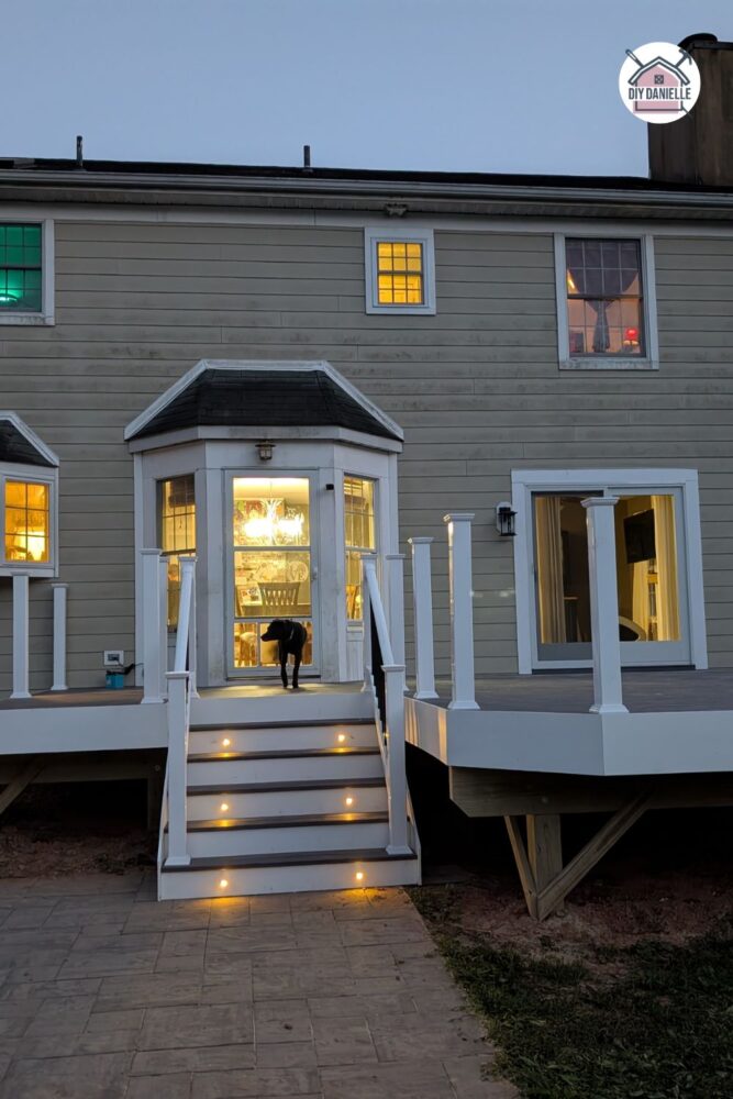 View from the pool side showing deck boards installed and lights on.