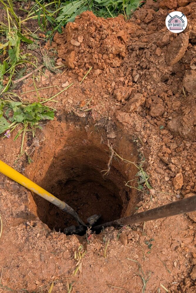 Close-up of a post hole being dug for the deck foundation