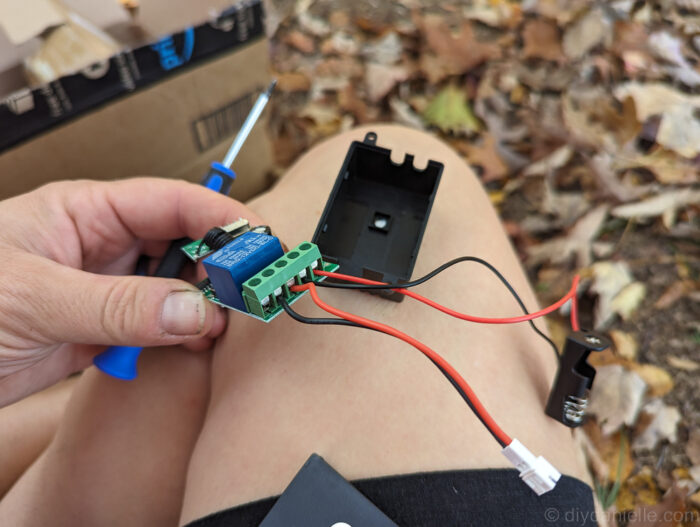 Step 3 of DIY animatronic wiring showing the cord with the white end positioned near the animatronic, ready to install but not yet connected.