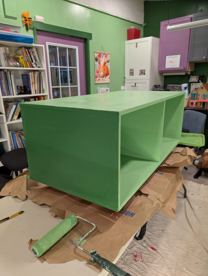 Green reptile enclosure stand built from 3/4-inch plywood, showing a box design with a top, bottom, divider, sides, and back for added strength.