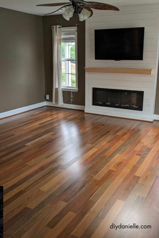 New hardwood flooring installed to match existing floors seamlessly in a living room renovation.