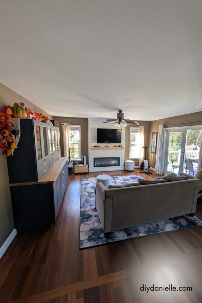 Unfinished fireplace mantle in a renovated living room, awaiting final color choice.