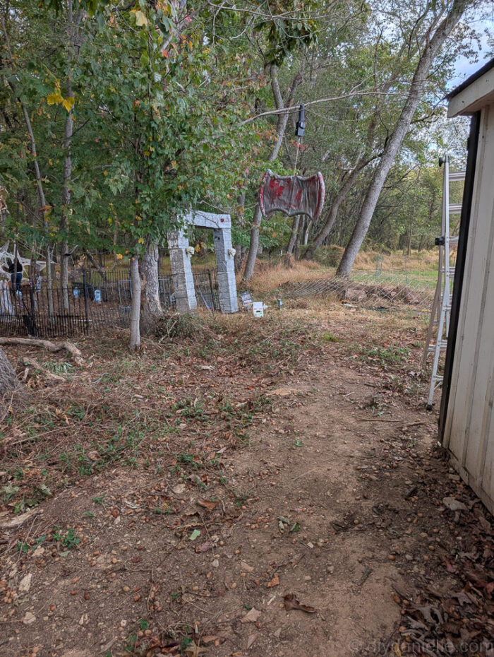 Skeleton positioned on a pyre with red lights underneath, creating the effect of a witch on fire for Halloween décor.