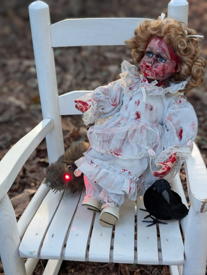 Eerie doll arranged on a chariot, adding a creepy touch to the Halloween scene.