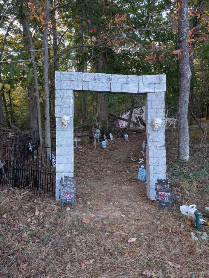 **Alt Text:**
Halloween graveyard setup featuring a DIY graveyard archway, part of a spooky outdoor display.