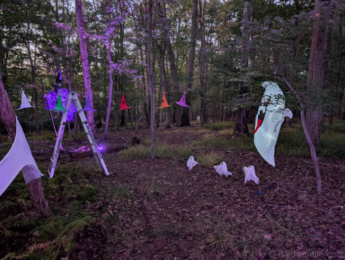 Hanging witch hats suspended above the path leading into the Halloween witch area.