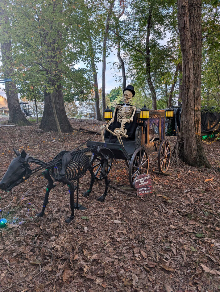 Giant Halloween pony animatronic with skeletons, part of a multi-feature display with lights and sound.