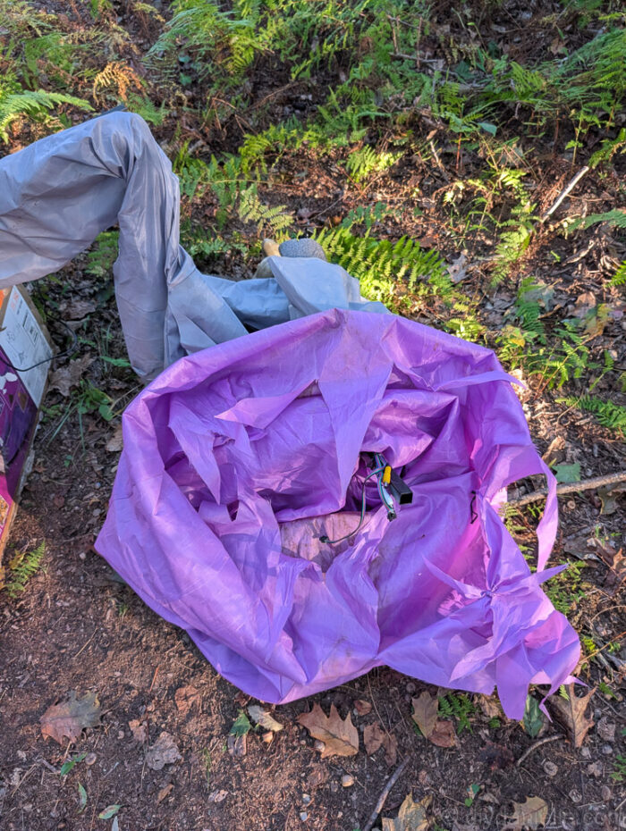 Close-up of curved rods locking into metal bars with foam padding and the witch’s dress string attached to the feet on a 12 ft. Hovering Witch Halloween decoration.
