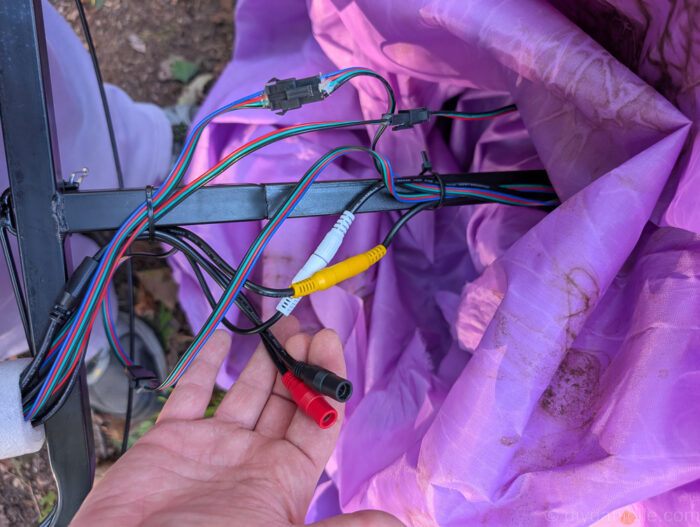 Close-up of three matching wires being connected during the setup of a 12 ft. Hovering Witch Halloween decoration.