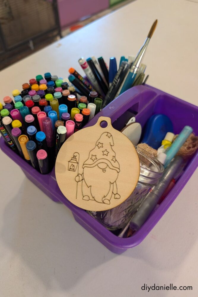 DIY ornament cut from a machine ready to be colored with acrylic markers and colored pencils for a personalized holiday decoration.