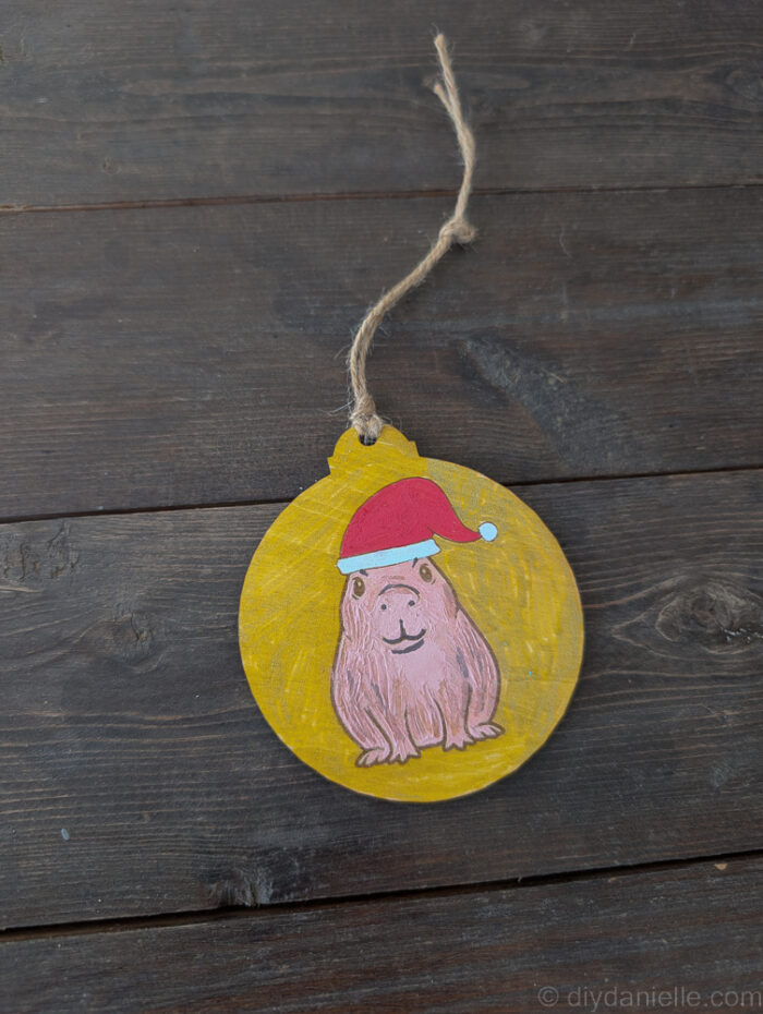 Brightly colored, finished DIY ornaments displayed together, ready for hanging on a Christmas tree.