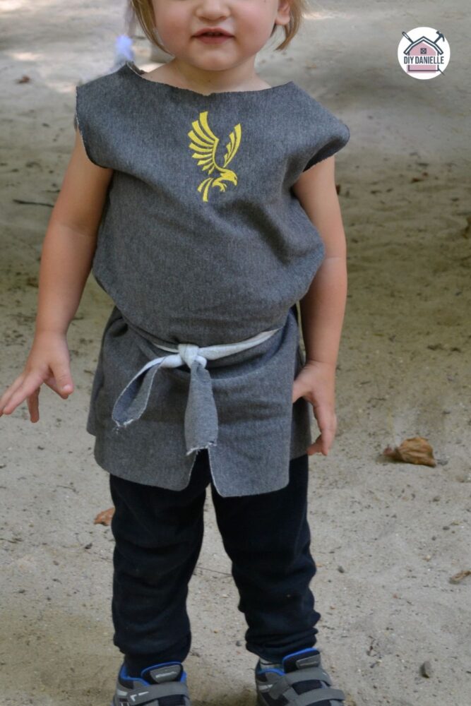 DIY knight costume... this is a simple tunic to sew and because sweatshirt fabric was used, no hemming was needed. VERY quick sew. The front is embroidered with a yellow eagle emblem, but you could use iron on vinyl too. 