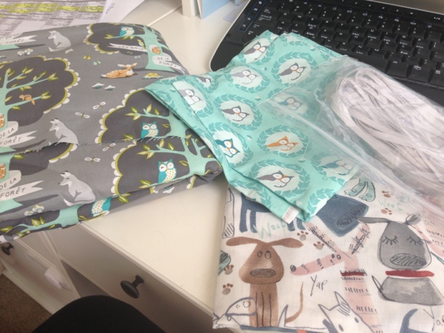 Forest animal themed fabric chosen to match the Tame Teal nursery. 

Fabric 1 is dark and light gray with light teal trees and fox, deer, owls and squirrels on it. 

Fabric 2 is two shades of teal with circle frames around owls of different colors (but the same exact design). 

Ignore the puppy fabric at the bottom... I couldn't resist getting that too. 